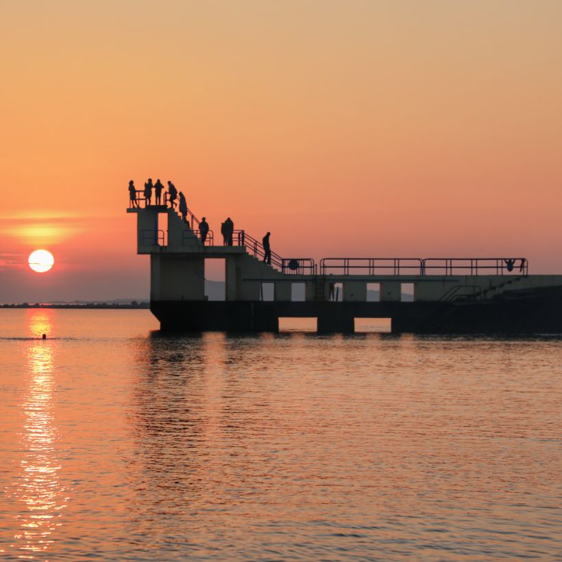 Blackrock Diving tower at sunset, people jumping off